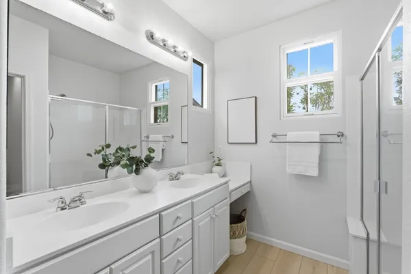 a bathroom with a double vanity sink mirror and double