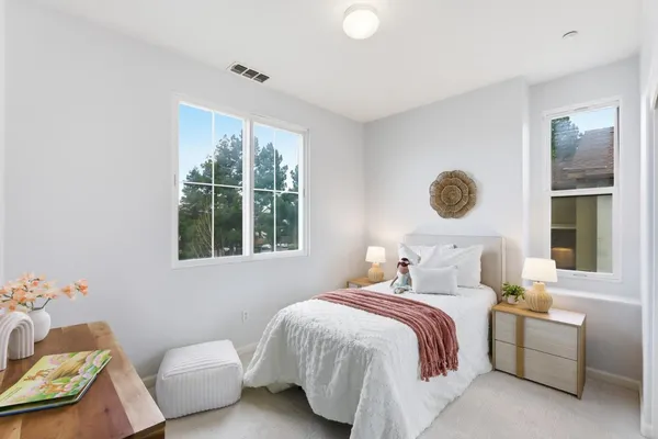 a bedroom with a bed and a window