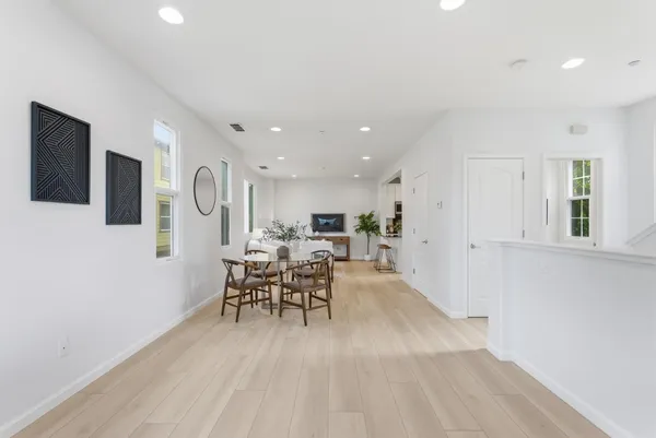a view of a dining room with furniture window and wooden floor