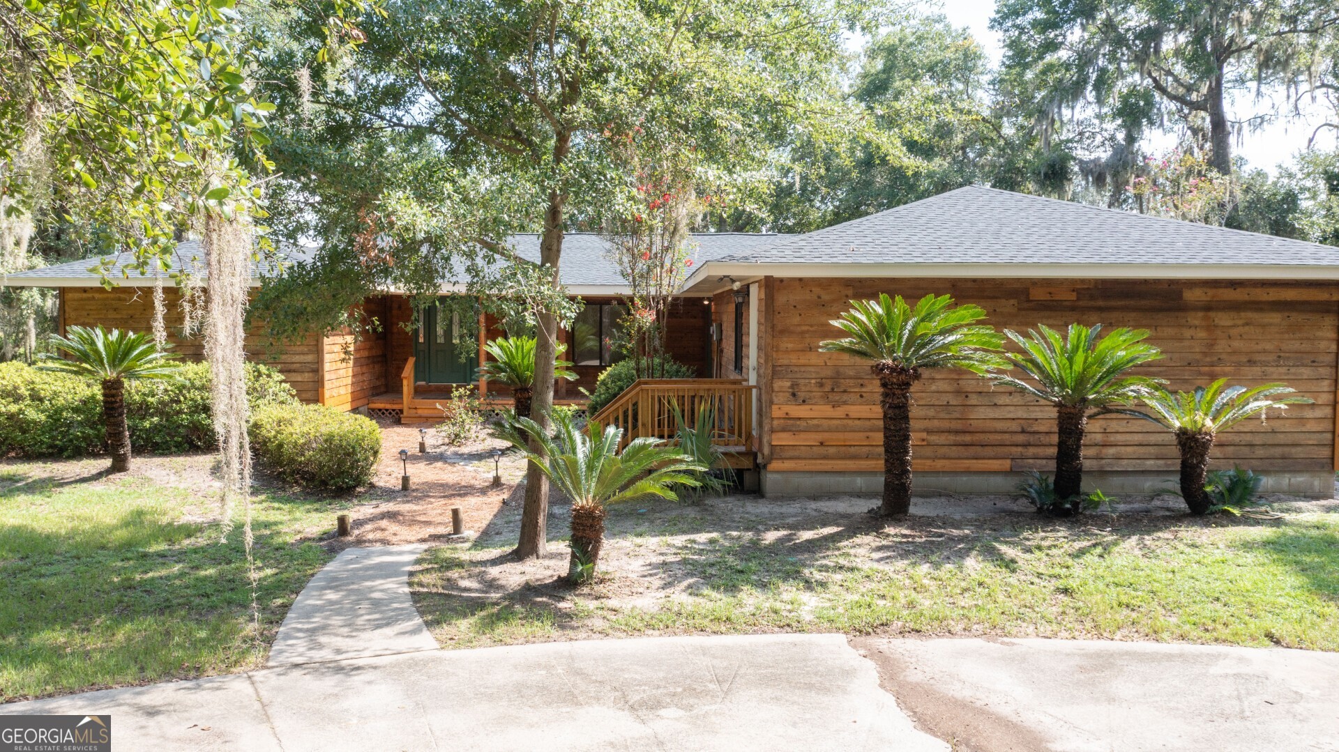 a view of a patio with table and chairs under an umbrella