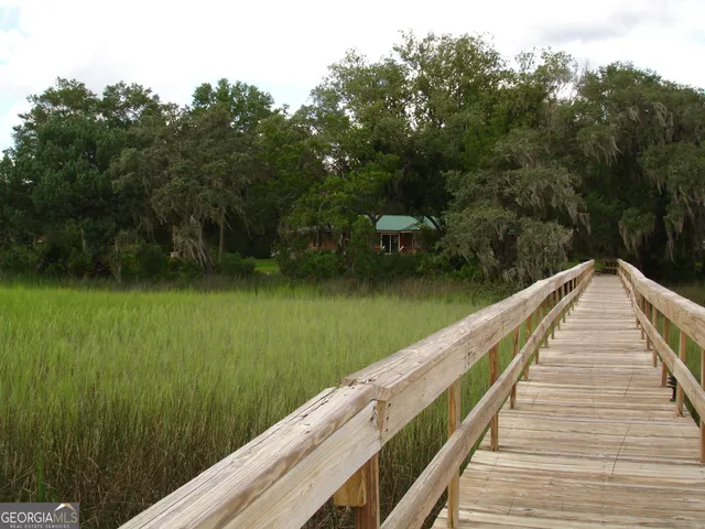 an aerial view of ocean beach and residential house with outdoor space
