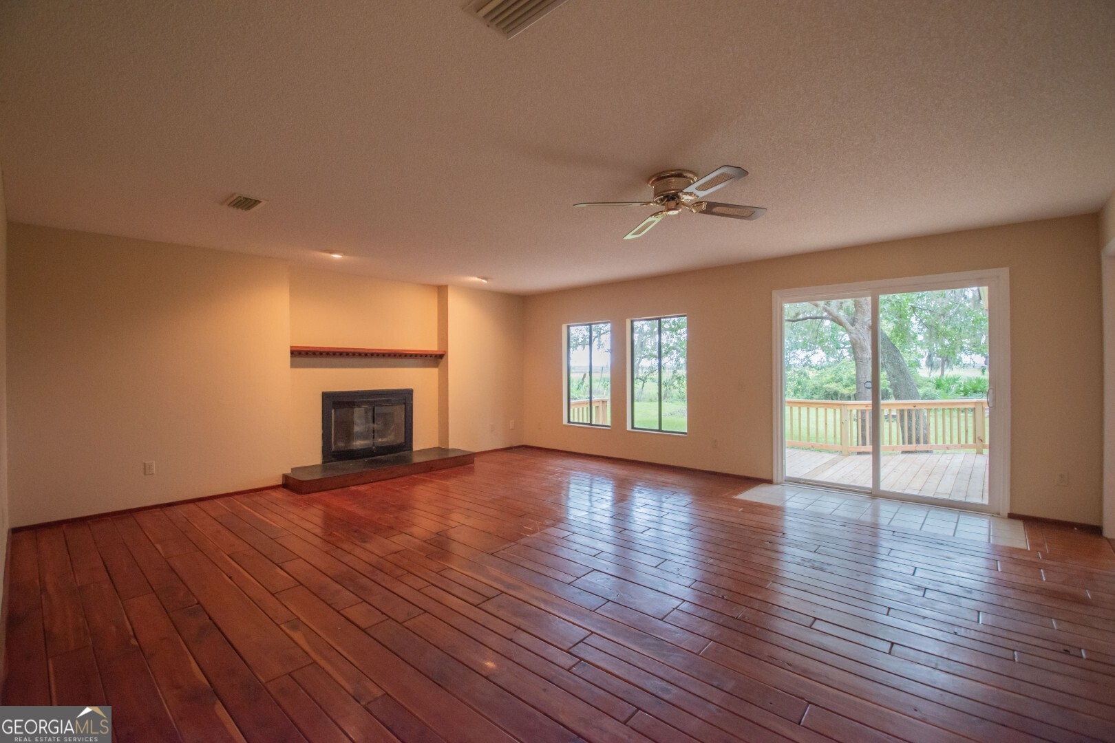 1924 Cedar Court Waverly, GA 31565 - Photo 26 of 78 a view of an empty room with wooden floor and a window