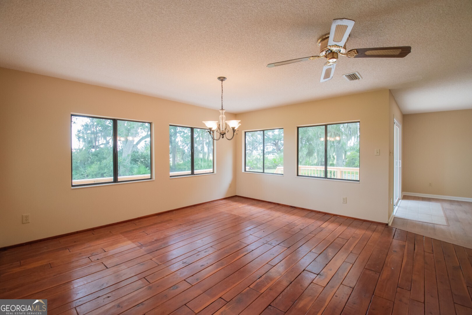 1924 Cedar Court Waverly, GA 31565 - Photo 29 of 78 a view of an empty room with a window and wooden floor
