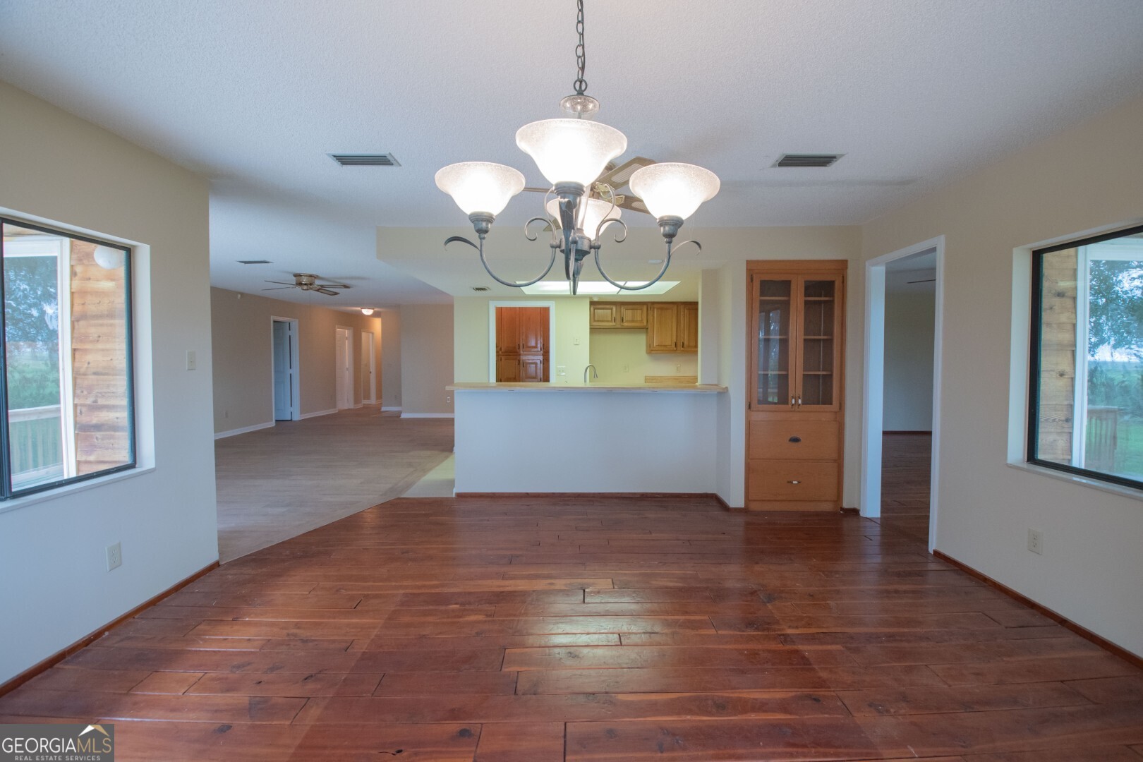 1924 Cedar Court Waverly, GA 31565 - Photo 31 of 78 a view of an empty room with a window and a kitchen