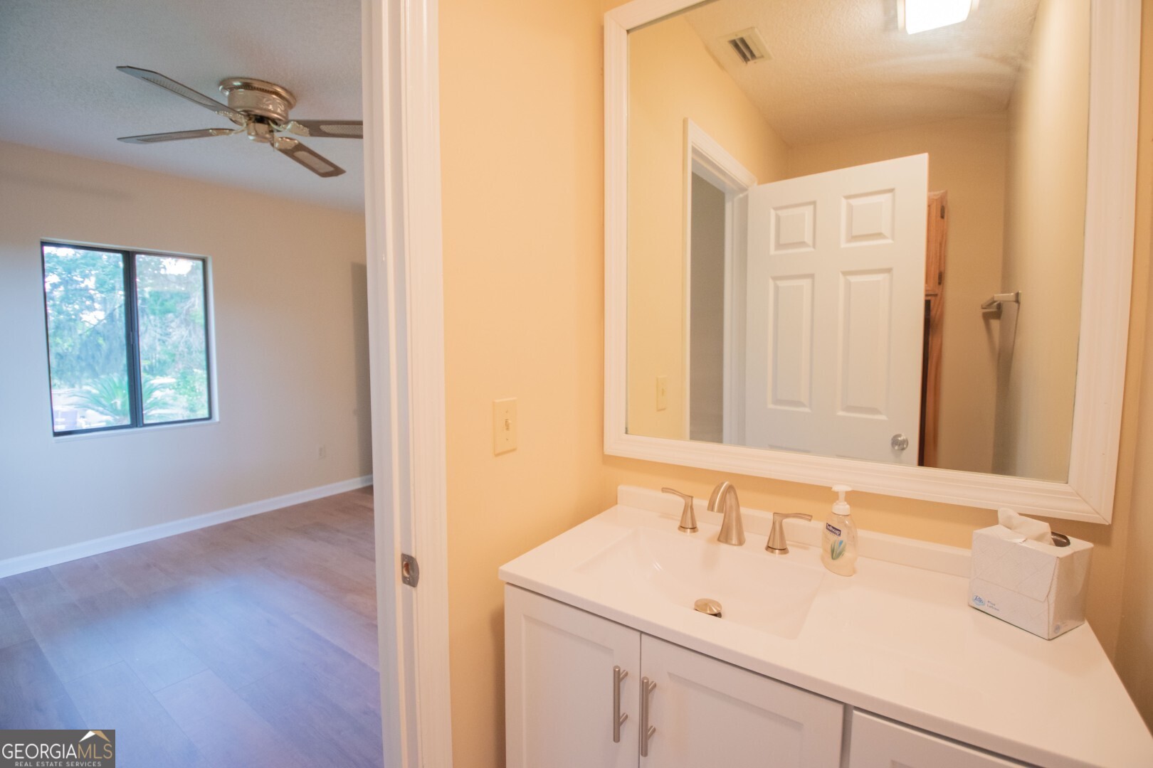 1924 Cedar Court Waverly, GA 31565 - Photo 37 of 78 a bathroom with a sink and a mirror