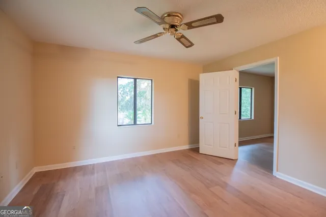 a view of backyard with deck and outdoor seating