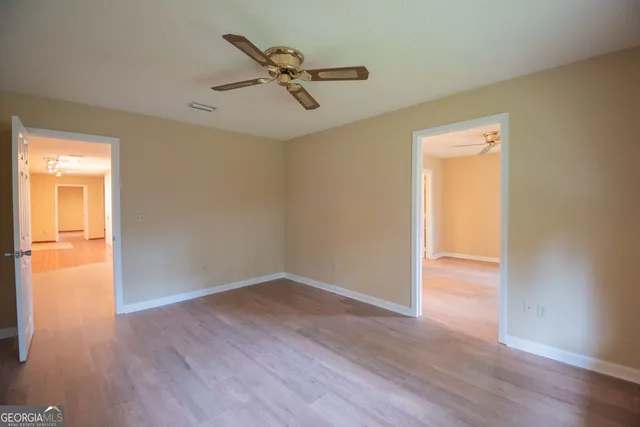 a view of a house with a yard and trees