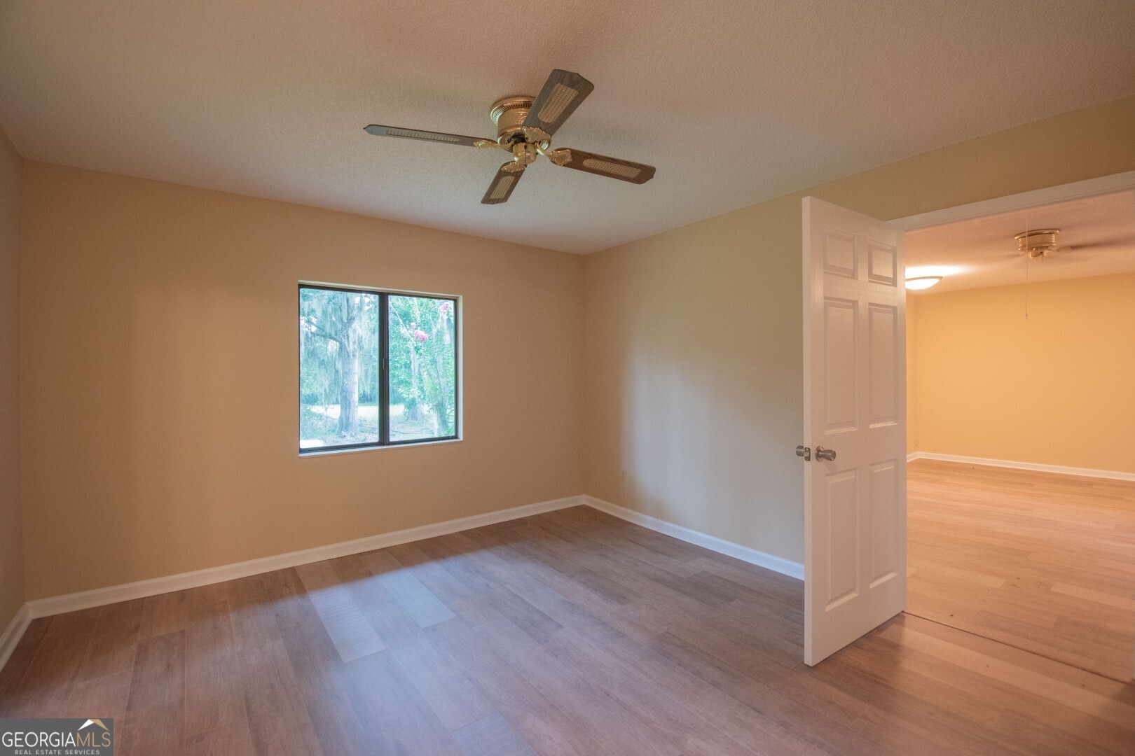 1924 Cedar Court Waverly, GA 31565 - Photo 44 of 78 an empty room with wooden floor fan and windows