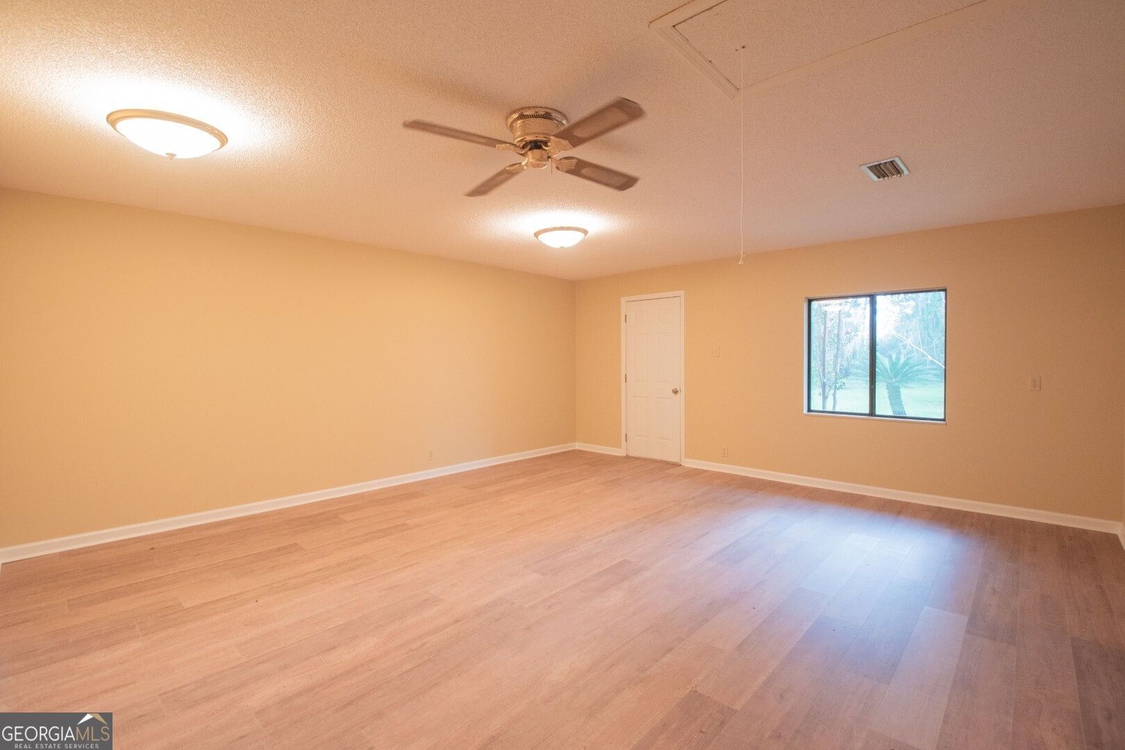 1924 Cedar Court Waverly, GA 31565 - Photo 48 of 78 an empty room with wooden floor fan and windows