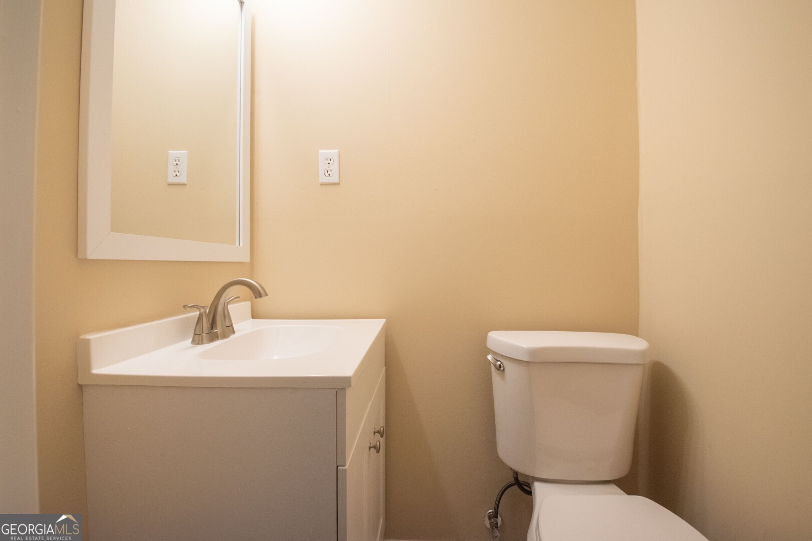 1924 Cedar Court Waverly, GA 31565 - Photo 52 of 78 a bathroom with a toilet sink and mirror