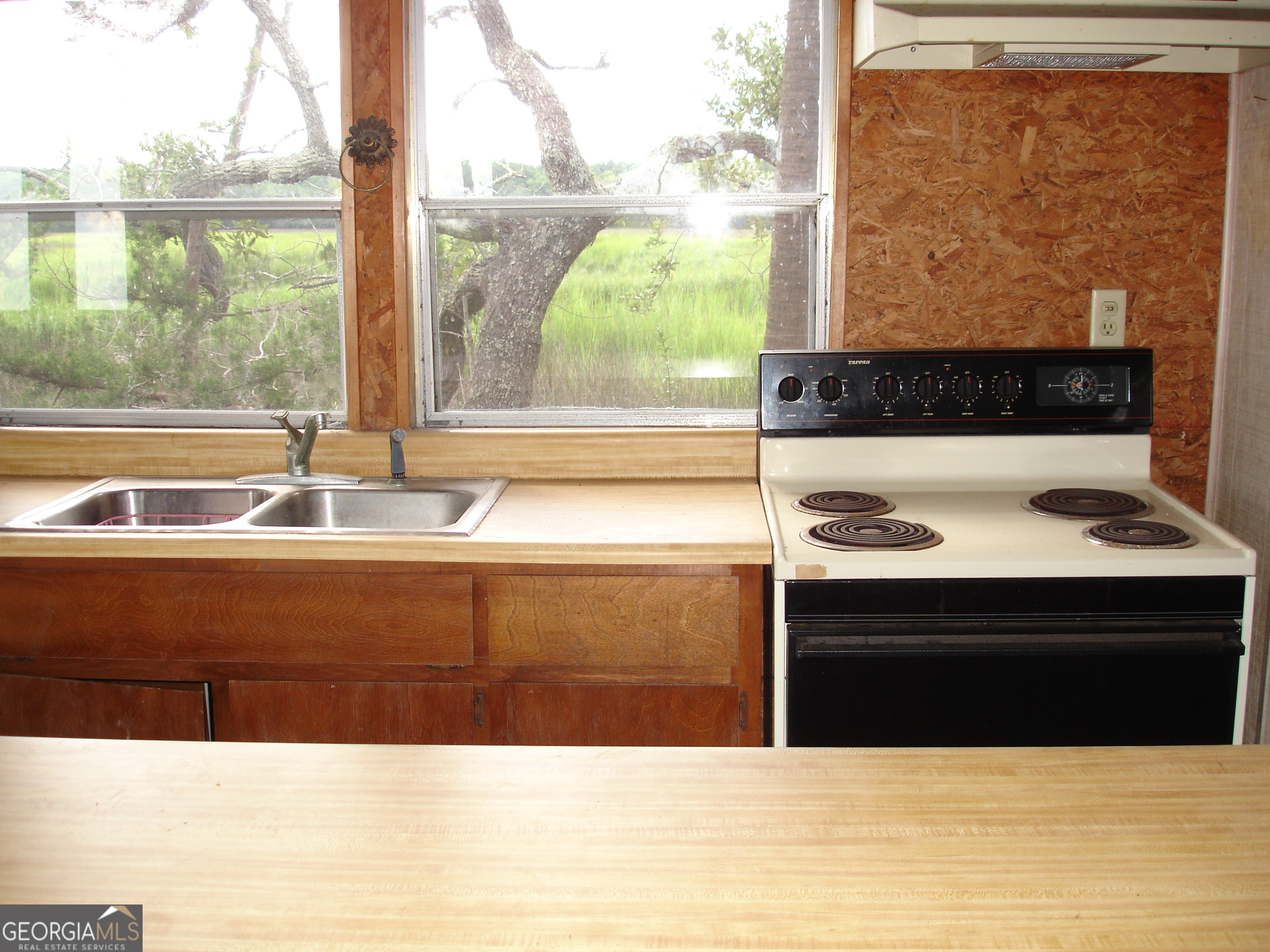 1924 Cedar Court Waverly, GA 31565 - Photo 69 of 78 a view of kitchen sink and a stove with wooden floor