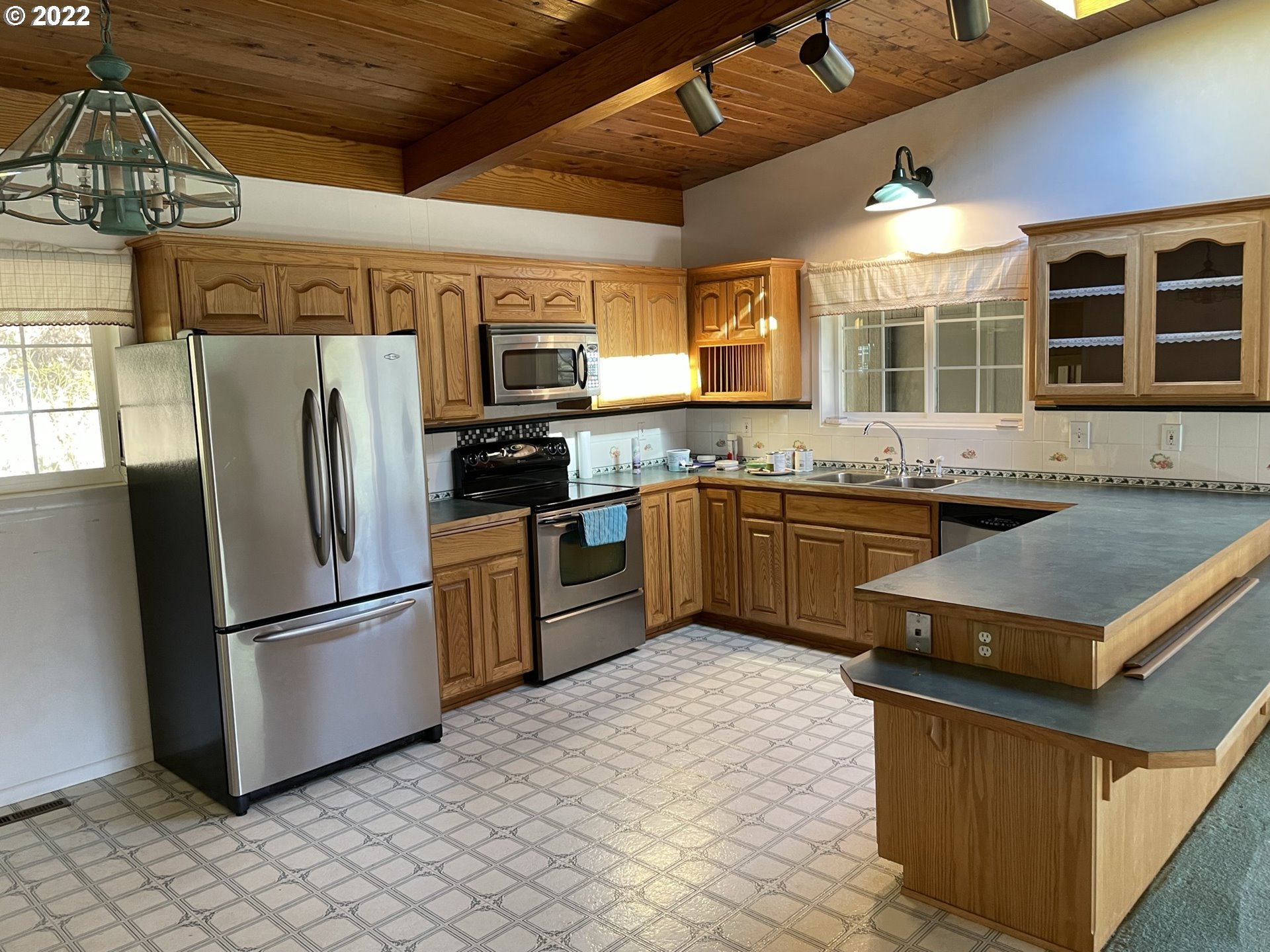 19975 Highway 36 Blachly, OR 97412 - Photo 7 of 32 a kitchen with stainless steel appliances granite countertop a stove a sink dishwasher a refrigerator and a microwave oven