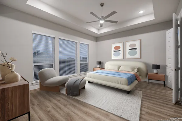 a spacious bedroom with a bed a couch and a large window