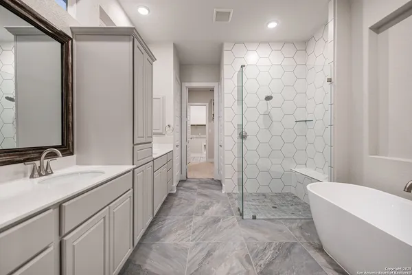 a bathroom with a double vanity sink toilet and shower