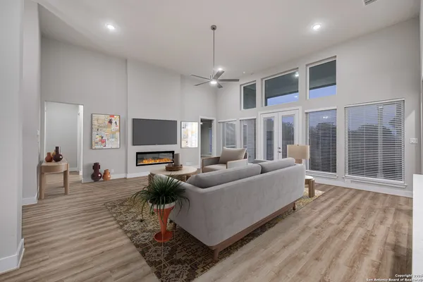 a living room with furniture a large window and a flat screen tv