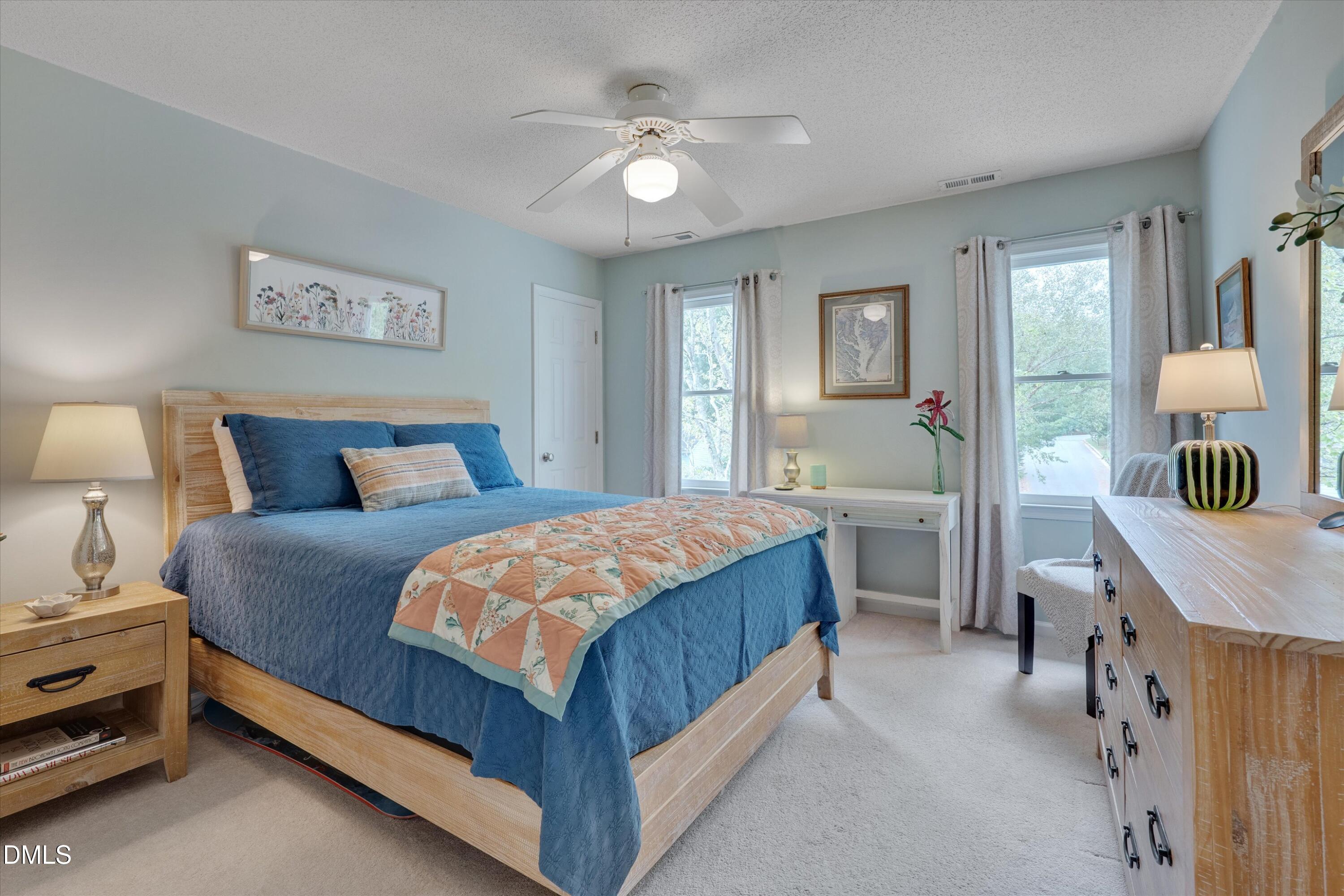 3301 Lassiter Street Durham, NC 27707 - Photo 21 of 32 a bedroom with a bed a chandelier and a dresser
