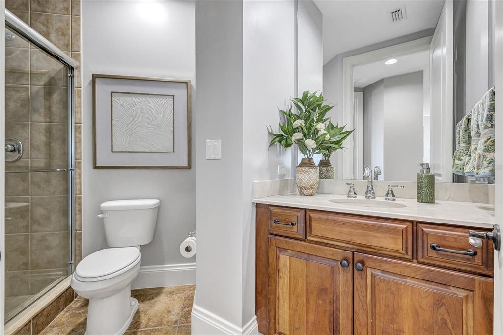 140 Riviera Dunes Way, Unit 206 Palmetto, FL 34221 - Photo 18 of 46 a bathroom with a toilet a sink and mirror