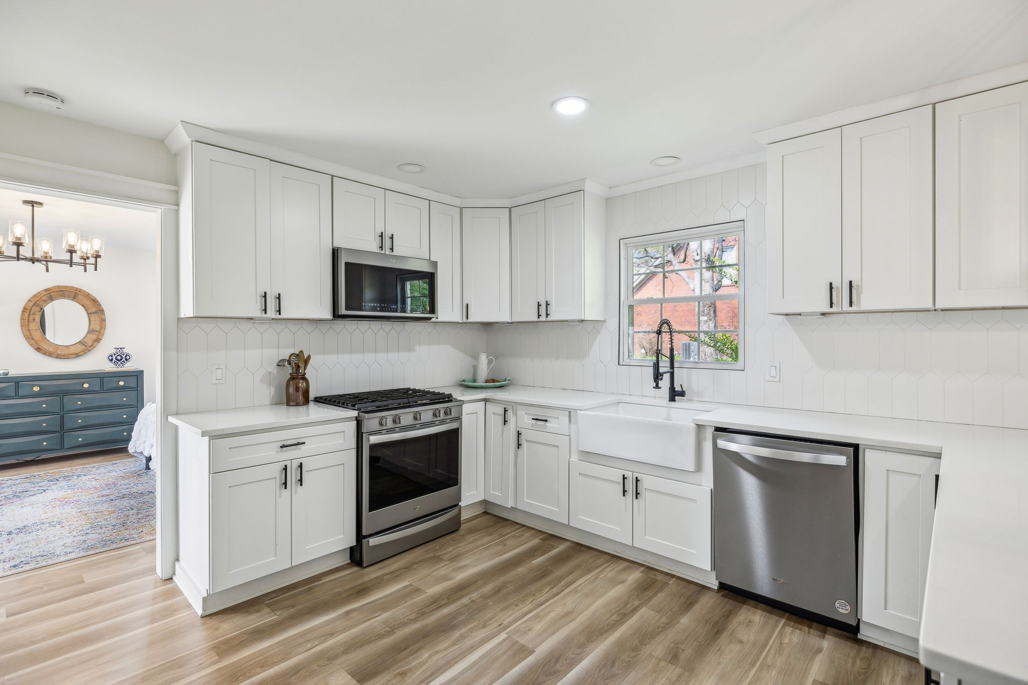 1103 Virginia Avenue Murfreesboro, TN 37130 - Photo 24 of 66 a kitchen with white cabinets stainless steel appliances and sink