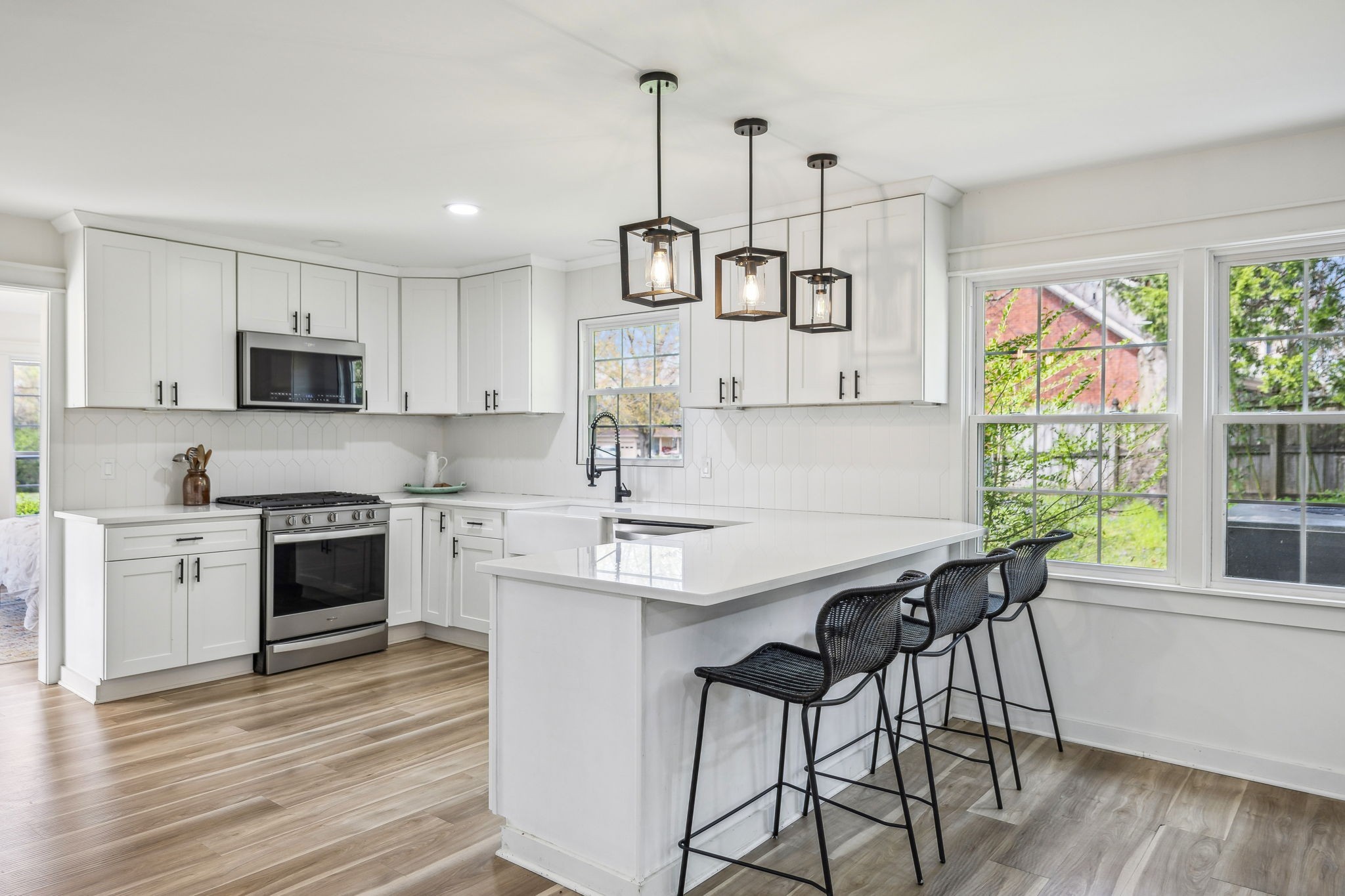 1103 Virginia Avenue Murfreesboro, TN 37130 - Photo 3 of 66 a kitchen with stainless steel appliances granite countertop a stove a sink a microwave a refrigerator and white cabinets with wooden floor