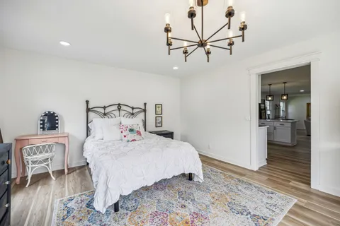 a bedroom with two beds and painting on the wall