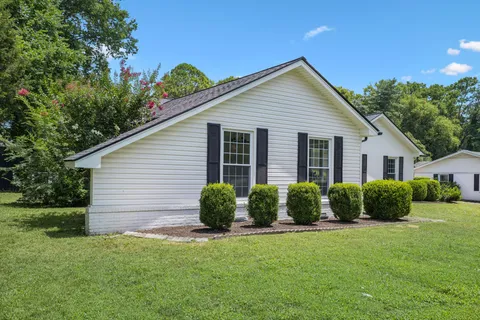 a view of a house with a yard and plants