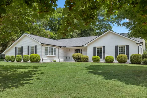 a view of a house with a yard and garage