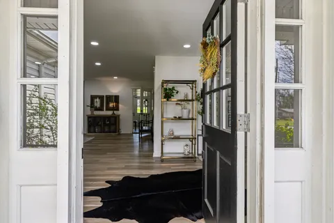 a living room with furniture and potted plant