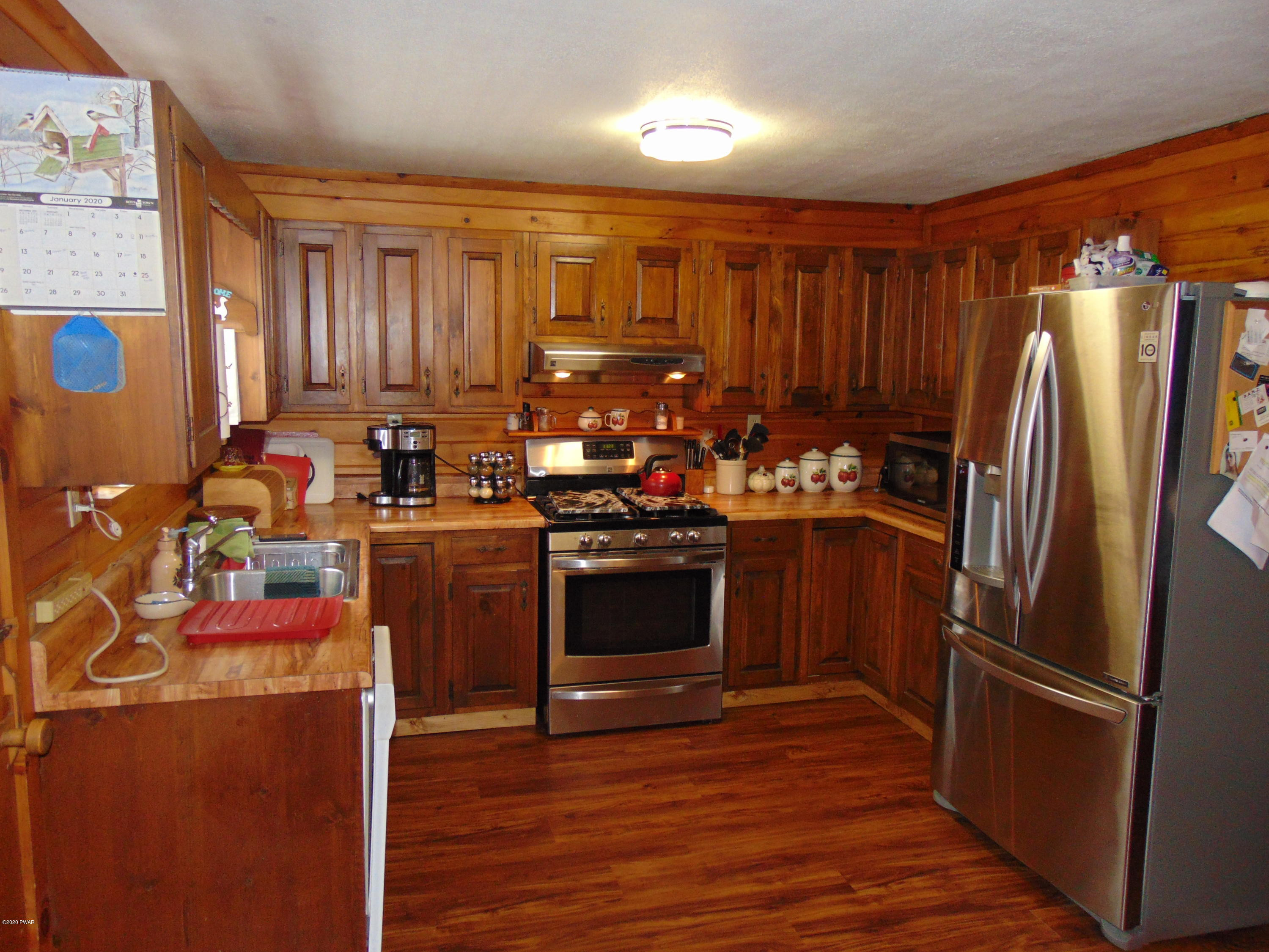 135 Puzo Road Montrose, PA 18801 - Photo 31 of 32 a kitchen with a refrigerator sink and cabinets