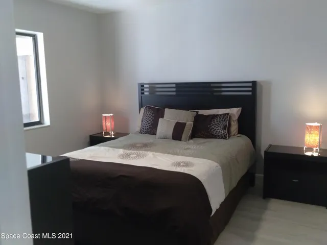 a bedroom with a bed and a night stand