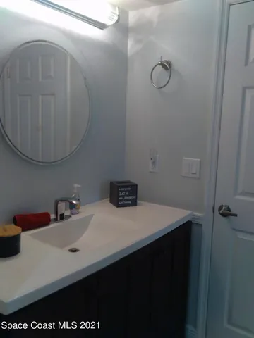 a bathroom with a sink vanity and a mirror