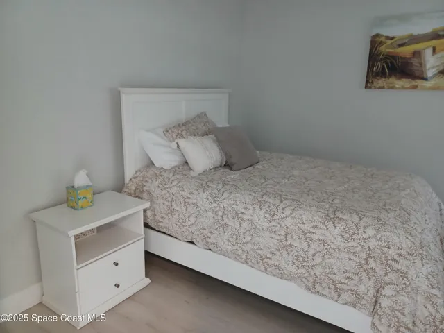 a large white bed in a white room