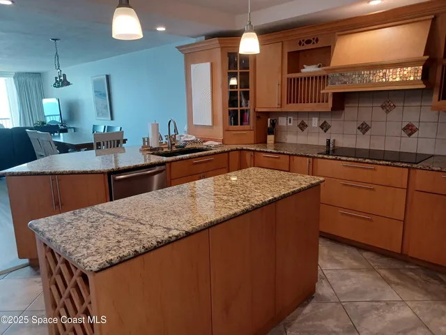 a kitchen with sink and wooden cabinets
