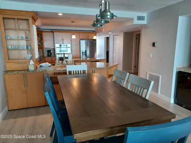 a view of a dining room with furniture and a chandelier