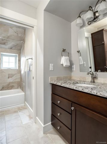a bathroom with a granite countertop sink double vanity and a mirror