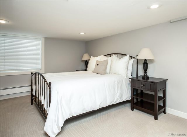 a bedroom with a bed and a night stand