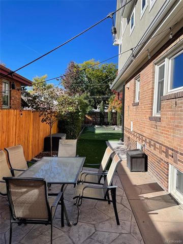 a view of a patio with table and chairs and potted plants