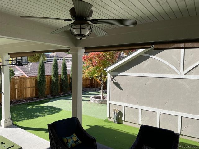a view of yard from deck with patio