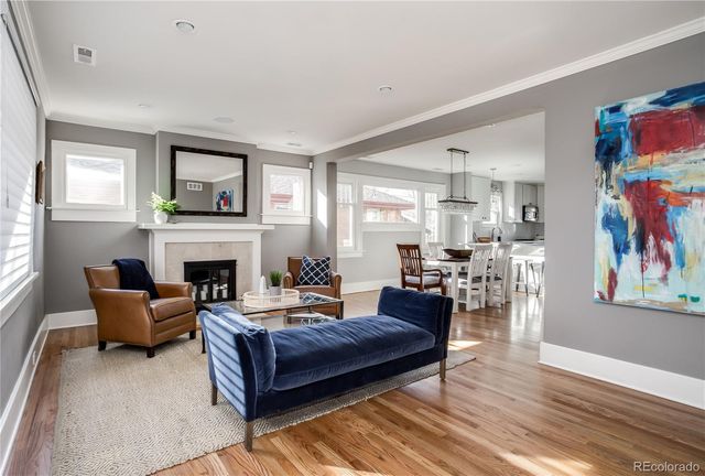 a living room with furniture fireplace and window