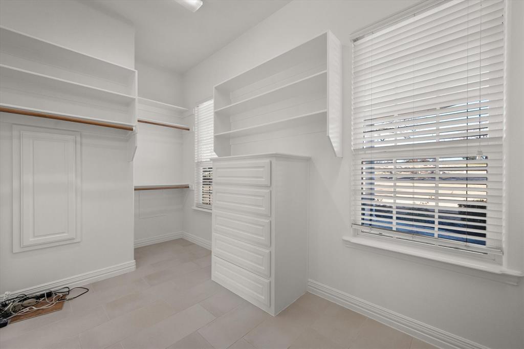 6056 Bennett Lawson Road Mansfield, TX 76063 - Photo 15 of 38 a view of walk in closet with clothes