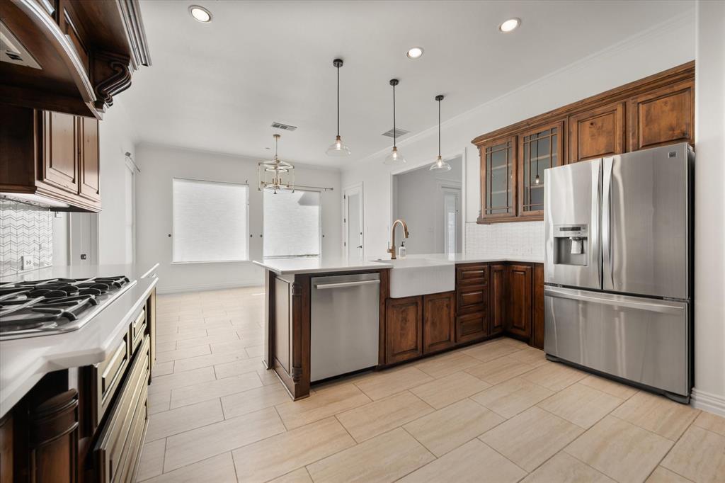 6056 Bennett Lawson Road Mansfield, TX 76063 - Photo 21 of 38 a kitchen with stainless steel appliances granite countertop a refrigerator a sink a stove and oven