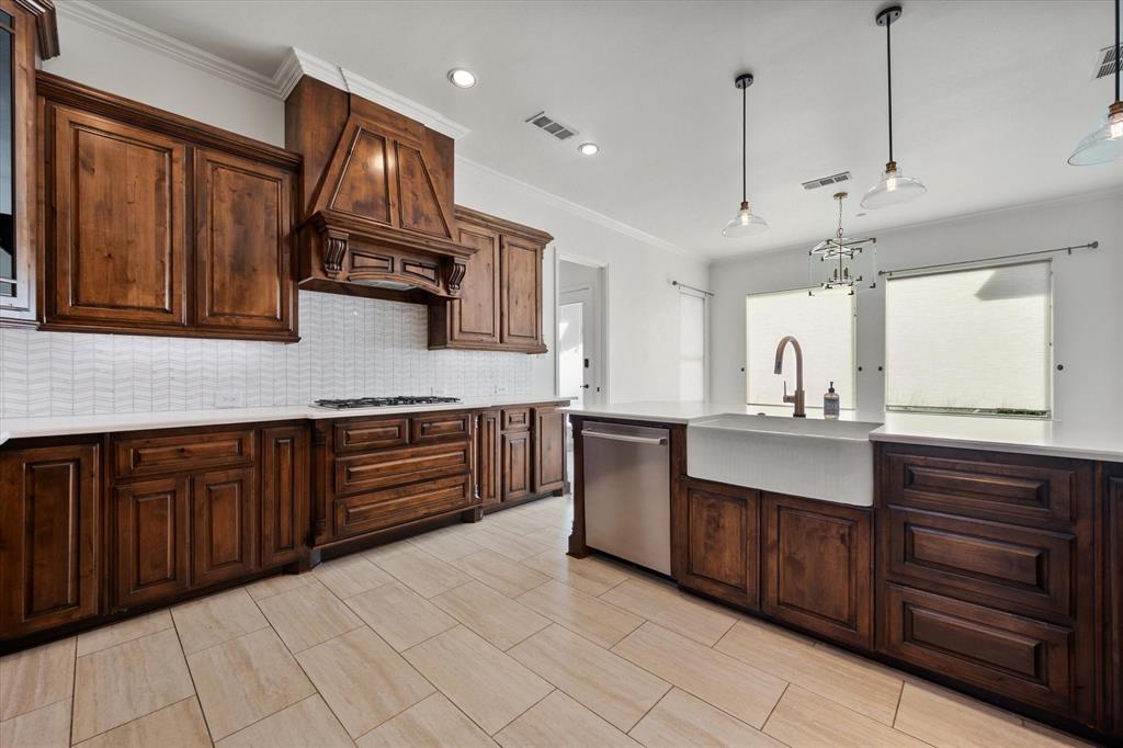 6056 Bennett Lawson Road Mansfield, TX 76063 - Photo 22 of 38 a kitchen with stainless steel appliances granite countertop a sink and cabinets