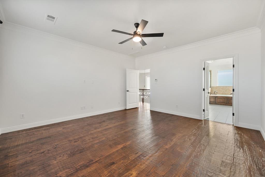 6056 Bennett Lawson Road Mansfield, TX 76063 - Photo 23 of 38 a view of a livingroom with wooden floor and a ceiling fan