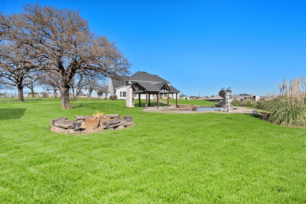 6056 Bennett Lawson Road Mansfield, TX 76063 - Photo 34 of 38 a front view of a house with garden and trees