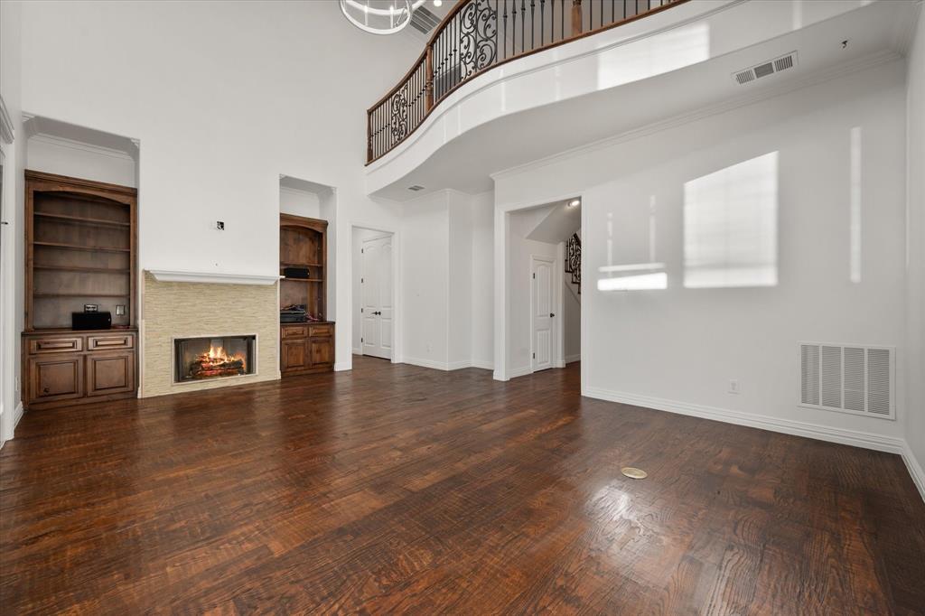 6056 Bennett Lawson Road Mansfield, TX 76063 - Photo 10 of 38 a view of a livingroom with wooden floor and a fireplace