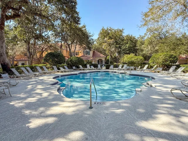 a view of a patio with a dining table and chairs under an umbrella