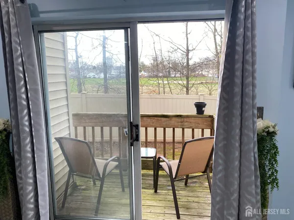 a view of a chair and table in the balcony