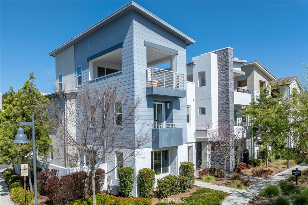a front view of a house with plants