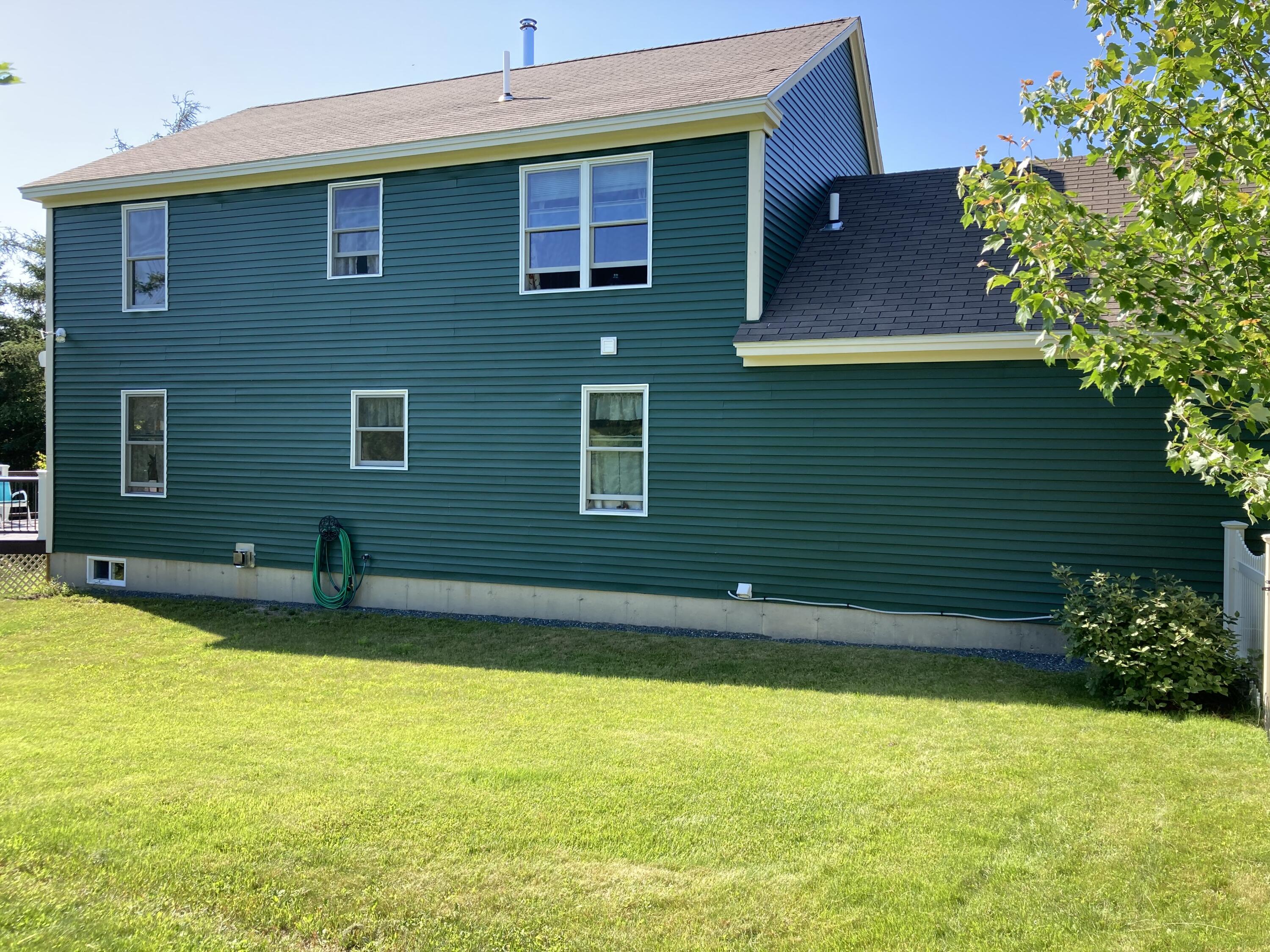 32 Boulder Cv Way Lamoine, ME 04605 - Photo 32 of 37 Rear of house from yard.