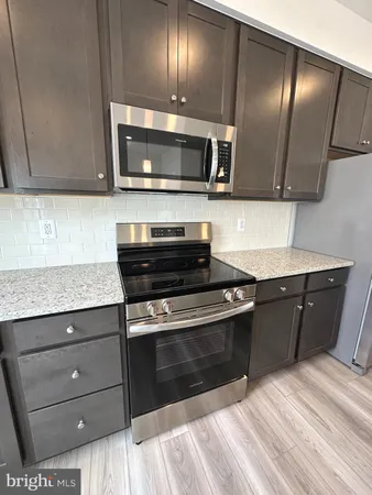 a kitchen with a sink and a stove top oven