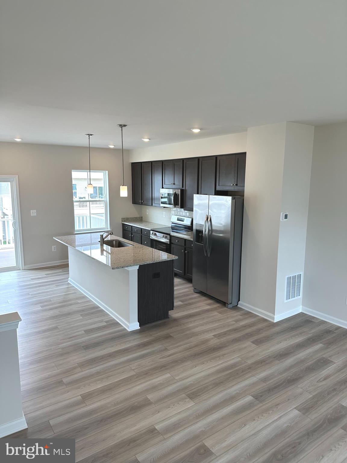 1258 Cedar Vly Road Ranson, WV 25438 - Photo 22 of 46 a large kitchen with kitchen island a sink dishwasher a refrigerator and wooden floor